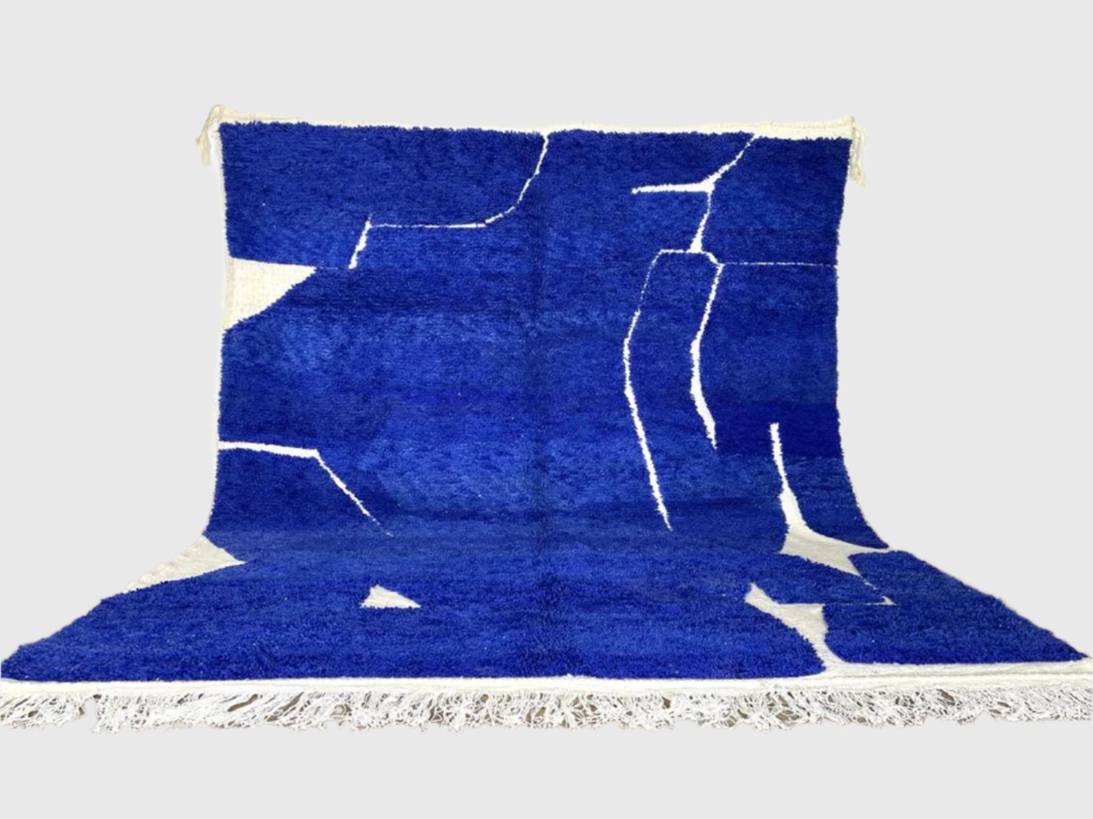Handmade Moroccan wool rug in bold cobalt blue with abstract white pattern