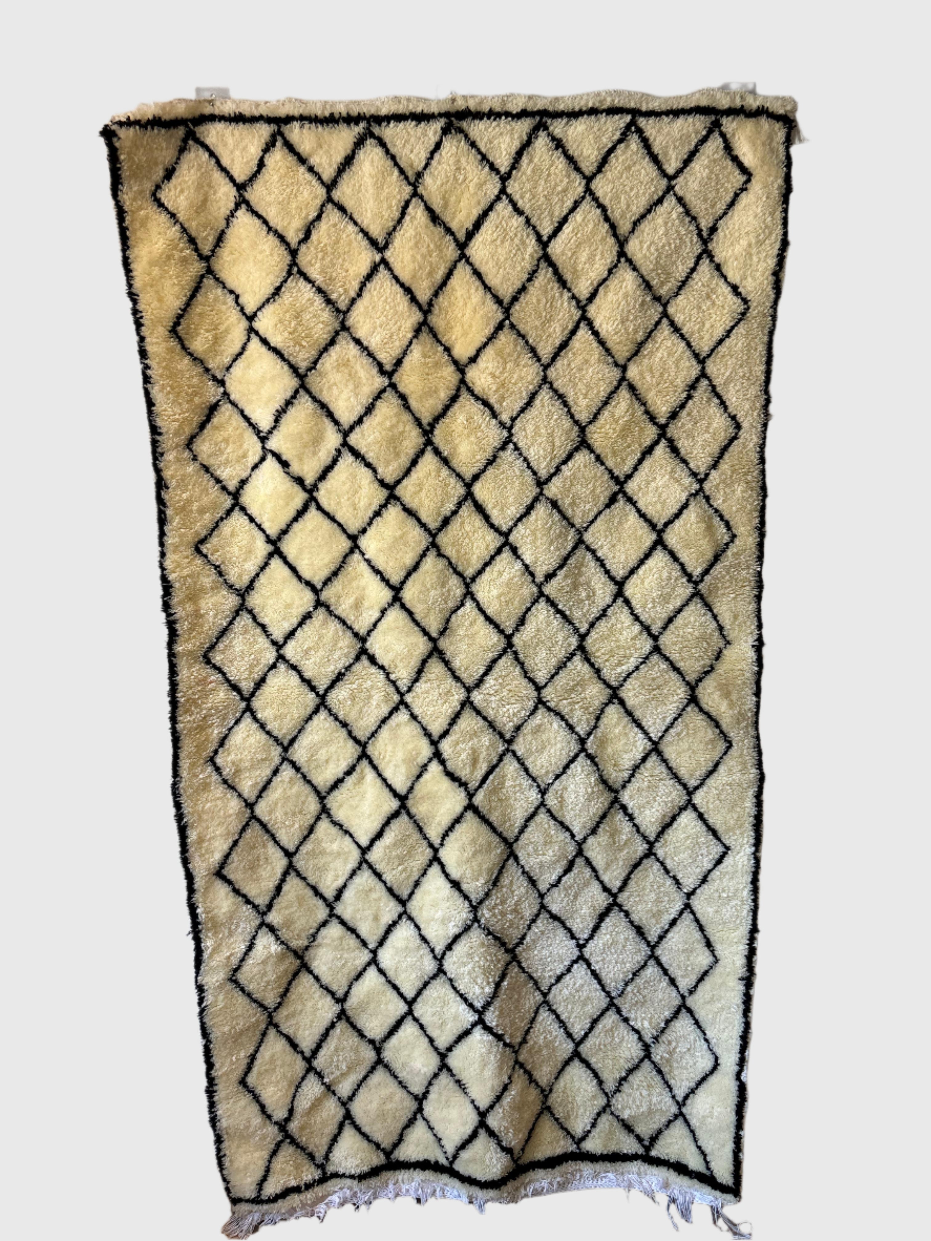 Handmade Beni Ourain Moroccan rug in cream wool with bold black diamond lattice pattern, 6x9 feet.