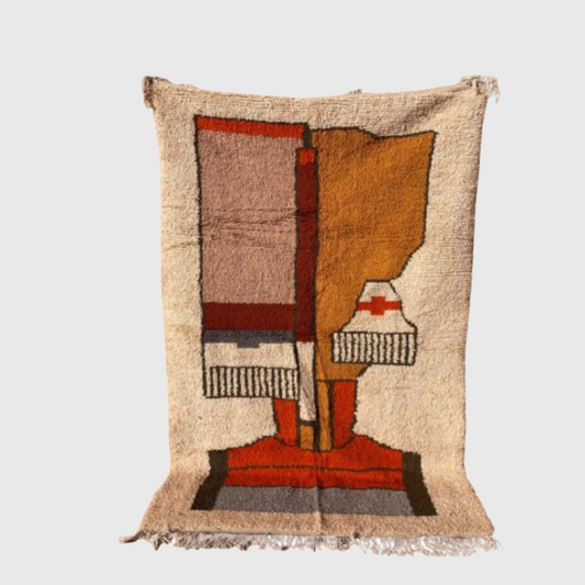 Abstract Moroccan wool rug featuring a modern face design in warm earthy tones on a neutral base.