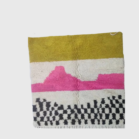 Modern wool rug with bold mustard yellow, vibrant pink, and black-and-white checkered design. Great as an accent piece.