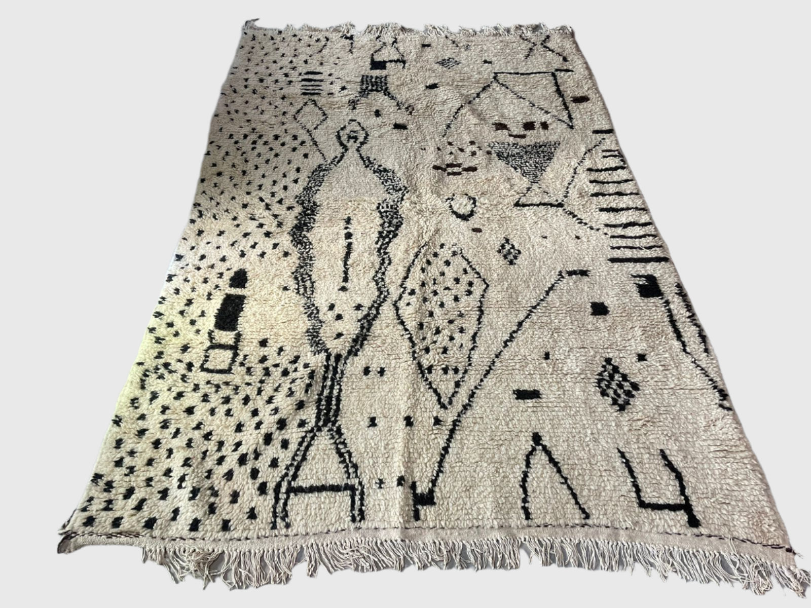 Handmade Moroccan wool rug in black and white with abstract tribal patterns, 6x9 feet