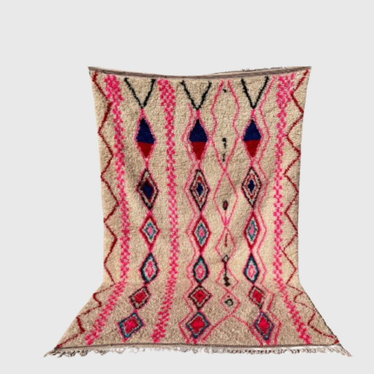 Colorful Moroccan boho rug with pink, blue, and beige diamond pattern on white background