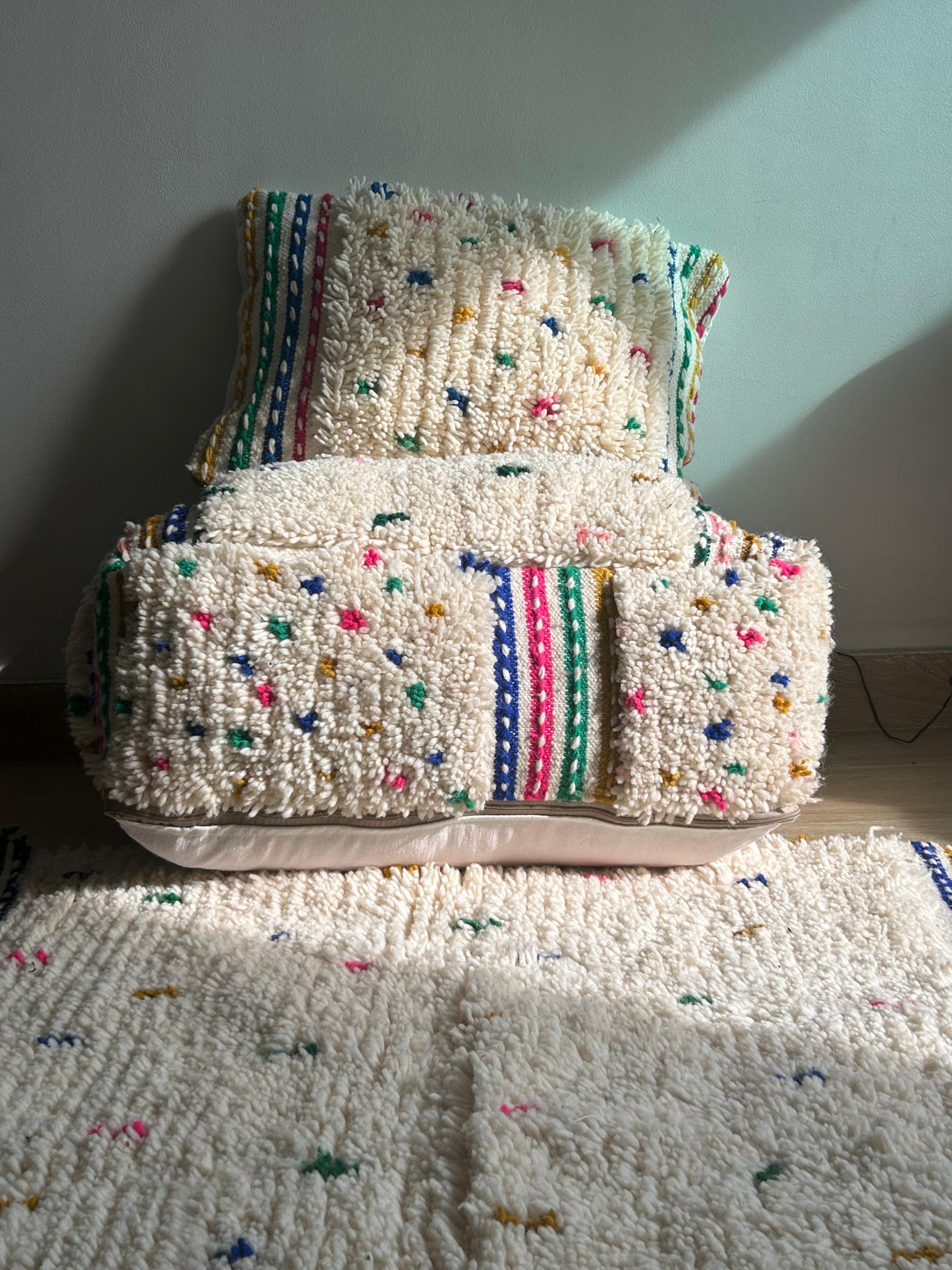 Set of Moroccan cactus silk cushions and throw in white with colorful embroidered dots and stripes, perfect for boho or cozy living spaces.