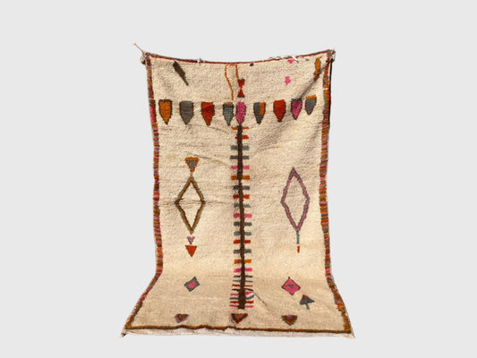 Handmade Moroccan wool rug with colorful tribal patterns in pink, orange, and black on beige background, 4x6 feet