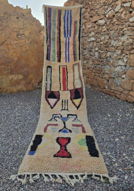 Colorful Moroccan runner rug in outdoor setting, handmade wool with abstract boho pattern, 7x2 feet