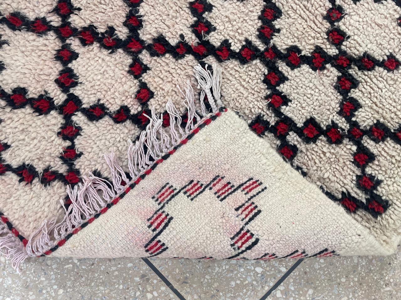 Front and back detail of Moroccan runner rug with black and burgundy diamond pattern and wool texture