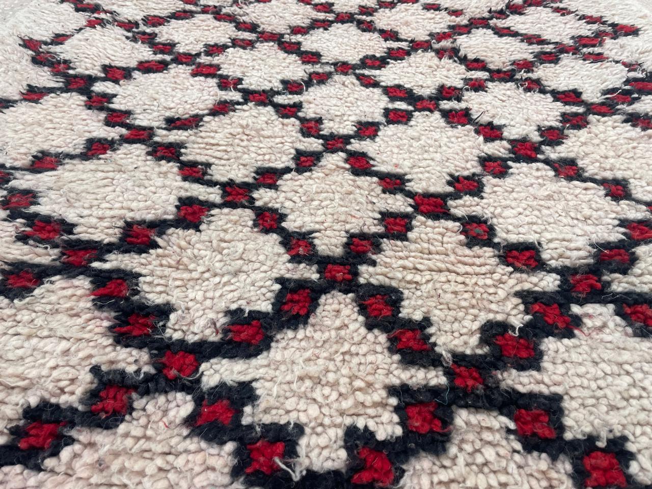 Close-up texture view of Moroccan runner rug with thick wool and black burgundy diamond pattern