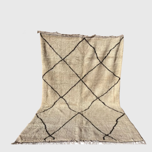 Minimalist Moroccan rug with black diamond lines on a neutral beige background, handwoven in Berber style